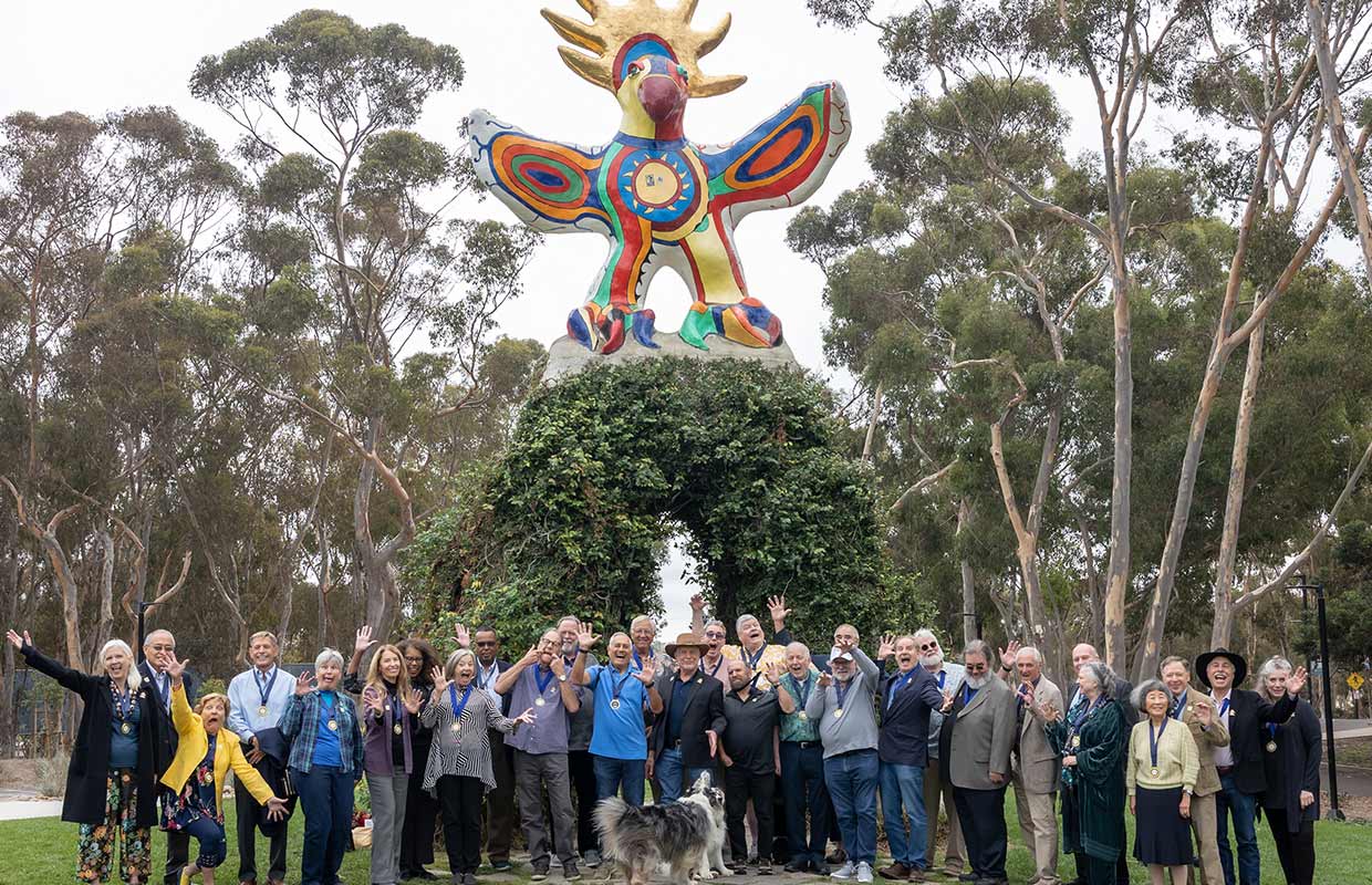 Class of 1973 group photo in front of Sun God statue