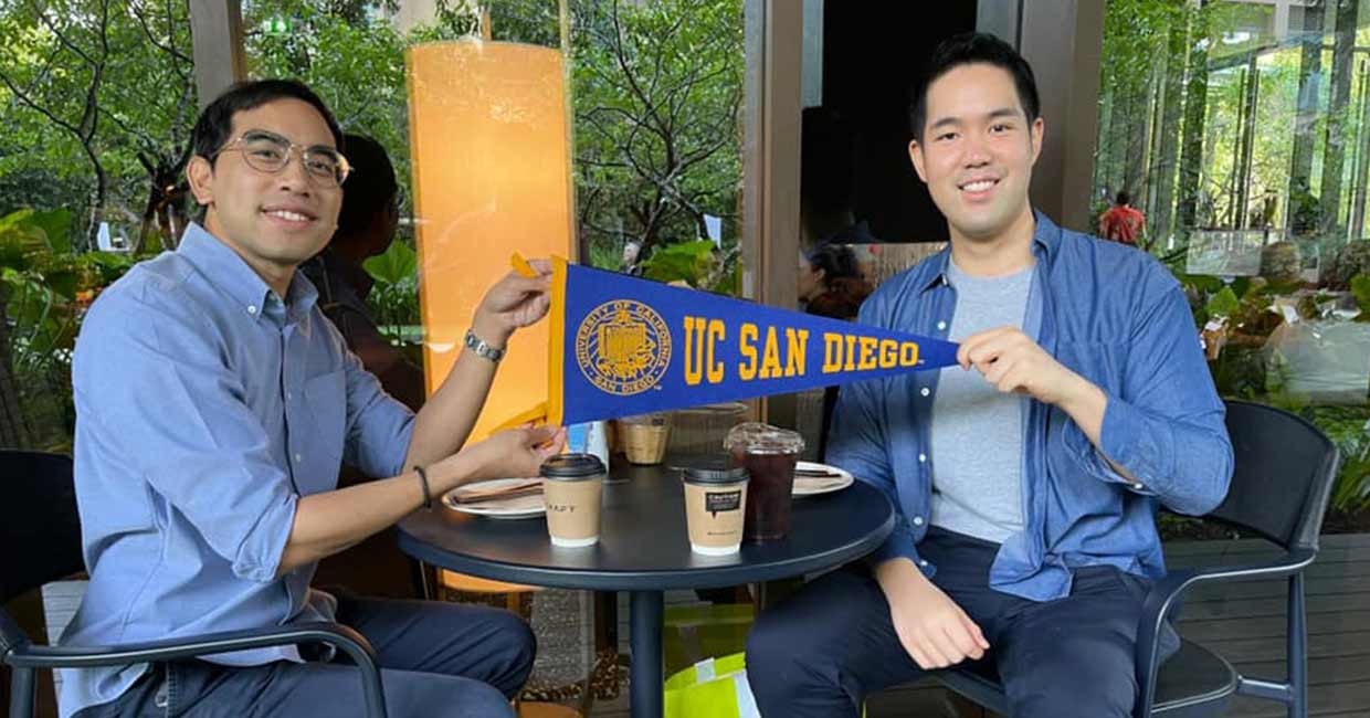 2 guys holding UC San Diego pennant