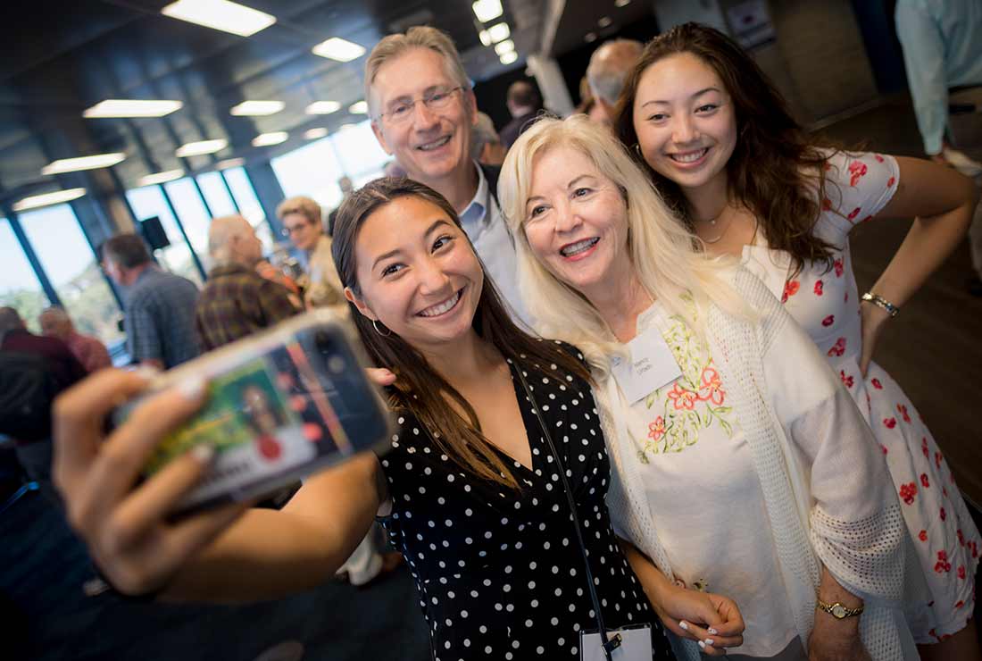 Group of alumni taking a selfie together