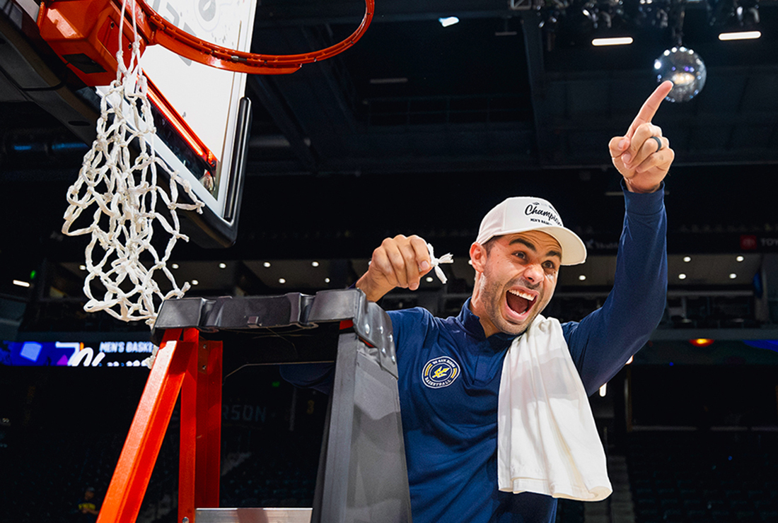 Clint Allard cutting down the winning basketball net