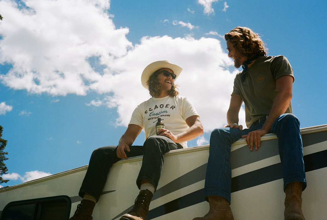 Mattson Smith and Elliott Shaw sitting atop a camper